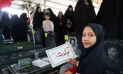 عکس | جشن تولد متفاوت دختر شهید مدافع حرم در کنار مزار پدرش