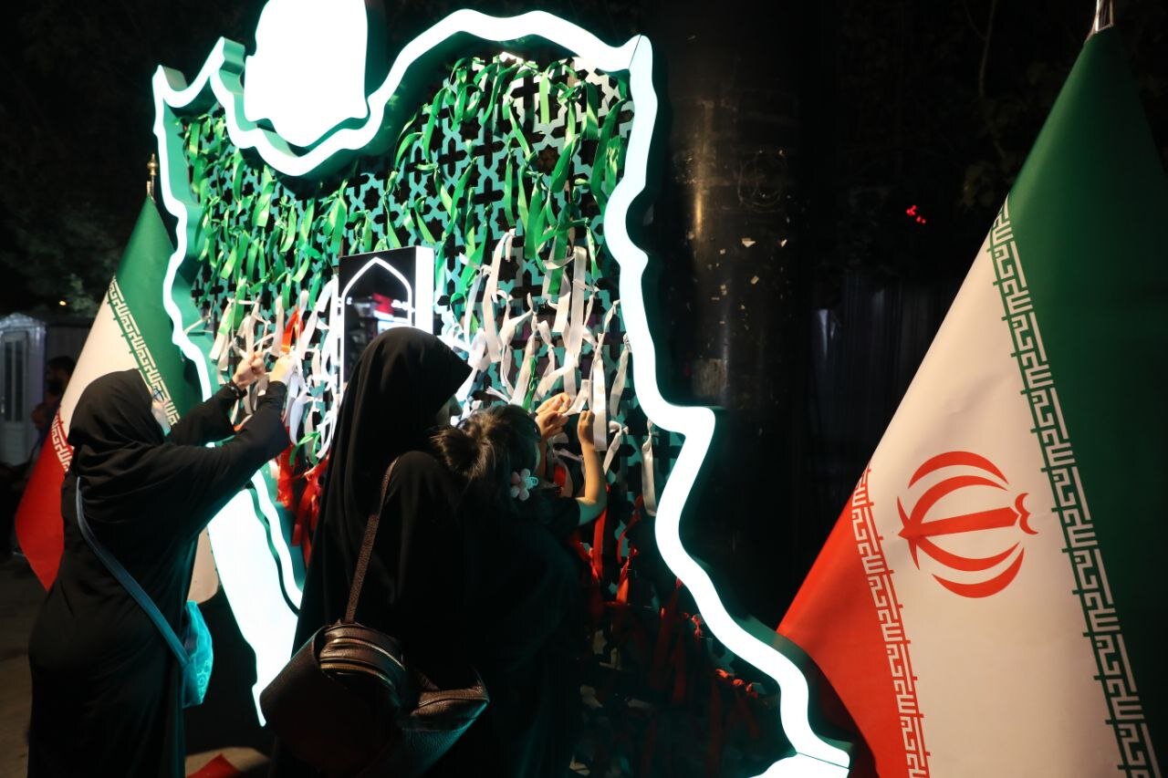 گره زدن روبان‌های سبز و قرمز و سفید نماد پرچم کشور عزیزمان